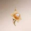Detail shot of a vintage gold flower pendant with enamel petals and a pearl center - March Daffodil Pendant Only (Without Chain)