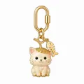 Detailed macro view of a cute gold-plated cat bag charm with straw hat and fishbone - Fishbone Cat Pendant