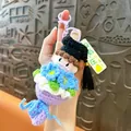 Handmade crochet graduation keychain with doll holding blue flower bouquet and tassel. - No Pressure Graduation Bouquet / Purple