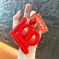 Handmade red crochet 100 number keychain featuring a lucky bell and golden exam charm - Academic Success (Number 100) / Red