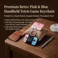 Pink and blue handheld retro Tetris game machine keychain on a velvet display pillow - Classic Game Console Pendant / Pink