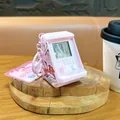 Mini pink arcade handheld game console keychain with retro tetris screen display on desk - Arcade Game Console Pendant / Pink