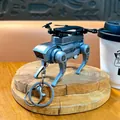 Silver mechanical robot dog keychain with drone propellers on wooden base. - Pull-Back Mechanical Dog Pendant / Gray