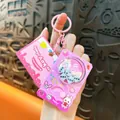 Adorable pink rotating dice toy keychain accessory with a cute game machine design style - Pink