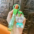 Translucent grey bear keychain with a vibrant green glitter strap and slogan detail - Green