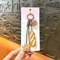 Maillard style cute pretzel bread keychain with fuzzy ball and star charm - Pretzel / Brown