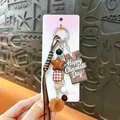 Cute chocolate themed keychain with fur ball and star charms for bag decor - Chocolate Pompom Charm / Brown