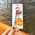 Cute Maillard-style pretzel bread keychain with pom-pom and football bag charm accessory - Pretzel / Brown