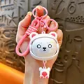 Close-up of a cute white bear keychain with a pink silicone strap and shocked expression. - Face-changing Panda Pendant / Pink