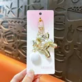 Elegant golden balloon dog keychain with white pearls and star charm for bag accessories - Pearl Balloon Dog Pendant / Gold