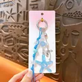 Creative blue acrylic starfish keychain charm with decorative beads and silver bow detail - Ocean Style Starfish Charm / Blue