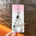 Y2K style silver headphone keychain charm with elegant ribbon and star pendants - Music Headphone Pendant / Silver