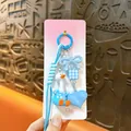 Cute blue nodding duck keychain bag charm featuring heart and bow accessories on pink card - Bobblehead Duck / Blue