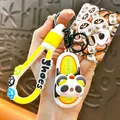 Cute cartoon panda slipper keychain with yellow silicone strap and bag charm accessory - Panda Rotating Slipper / Yellow