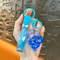 Ocean series blue conch keychain with oil-filled dolphin charm and glittery strap - Dolphin
