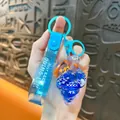 Blue sea shell liquid keychain featuring a cute clownfish and silver glitter stars - Clownfish