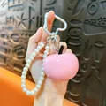 Cute pink resin apple keychain accessory with white pearl beaded wristlet and heart-shaped clip - Pink