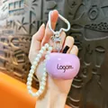 Creative pink resin apple keychain pendant with elegant pearl strap and heart carabiner - Purple