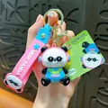 Cute cartoon panda keychain featuring a panda with blue shirt and pink wrist strap - Music Panda Keychain / Pink