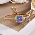 Elegante goldene Damen-Armbanduhr mit quadratischem blauem Zifferblatt und Kristallen - Goldblau
