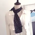 Close-up detail of a navy blue polka dot skinny scarf styled on a white shirt - Ink Polka Dots / 10*100cm