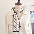 Detailed view of a French retro polka dot ribbon scarf tied on a white shirt neck - Cloud Polka Dots / 10*100cm