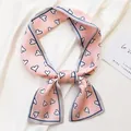 Close-up of a stylish pink silk skinny scarf with heart patterns on white fabric - Peach Heart Pink / 10*100cm