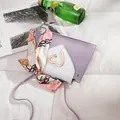 Close-up of stylish mini purple and white crossbody bag with heart buckle and silk scarf - Mini Style (20x5x12cm) / Purple