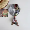 Close-up detail of a Van Gogh oil painting style silk twilly scarf tied in a decorative knot. - Rose Anemone