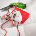 Close-up of a red and white mini square bag with a golden heart buckle and silk scarf - Mini Style (20x5x12cm) / Red