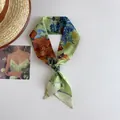Macro view of a skinny silk scarf featuring Van Gogh oil painting style in green - Daisy