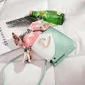Close-up of mini green and white square bag with gold heart buckle and silk scarf accessory. - Mini Style (20x5x12cm) / Light Green