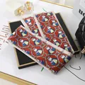 Detailed view of a long satin scarf with bird and chain pattern for bag styling - L040-10-04 Yellow-crested Chicken - Red