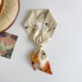 Detailed view of narrow silk scarf with elegant crane oil painting pattern on white - Brown Autumn Mountain Swallow