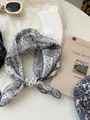 Detailed close-up showing the blue paisley pattern on a cotton linen bandana scarf - 07 Cashew White