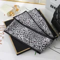 Close-up of leopard print chiffon scarf with artistic cat eye patterns - L040-11-02 Leopard - Black
