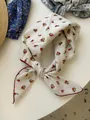 Detail view of a vintage floral cotton linen bandana tied in a stylish decorative knot - 10 Small Bouquets Of Rice