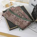 A detailed close-up showing the leopard print and feline pattern of this satin skinny scarf. - L040-11-05 Leopard - Green