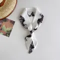 Close-up detail of a white narrow silk hair band featuring a black landscape ink painting - White Landscape Painting