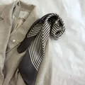 Elegant black and white chevron striped silk square scarf styled on a beige wool coat - Gray / 70*70cm