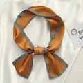 Close-up of a ginger silk twilly scarf with a black and white striped border - Warm Orange Trim / 10*100cm