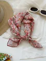 Detailed view of a retro floral cotton linen square scarf tied in a stylish knot - 24 Full Of Pollen