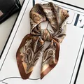 Elegant brown paisley silk-like scarf tied in a bow on a Vogue magazine background - South American Cashew Flower - Coffee