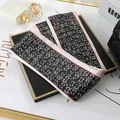 Elegant narrow silk satin scarf featuring black and white logo print for hair or bag styling - L040-24-02 Double C Letters - Black