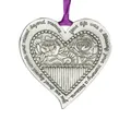 Detailed view of silver heart metal ornament with engraved floral design - Heart