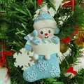 Detailed close-up view of a personalized resin snowman Christmas stocking tree ornament - Blue Engraving