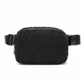 Close-up of black sherpa belt bag showing soft fleece texture and sturdy plastic buckle. - Black