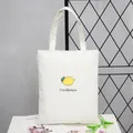 Simple white canvas tote bag featuring a minimalist lemon graphic for daily shopping - Lemon White