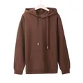 Detailed view of a brown oversized hoodie with drawstring aglets and a kangaroo pocket. - M / Tops / Coffee