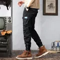 Detailed side view of black vintage cargo jogger pants with multi-pockets and ankle zippers - 28 / Bottoms / Black